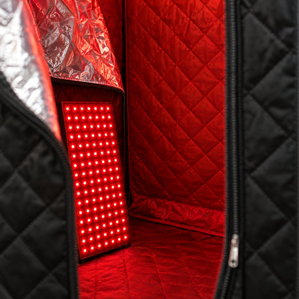 Close-up of the red light panel inside the quilted sauna tent