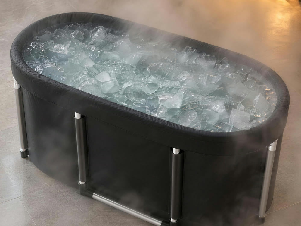 The Fold-Away Plunge, a black oval tub filled with ice water, in soft steam